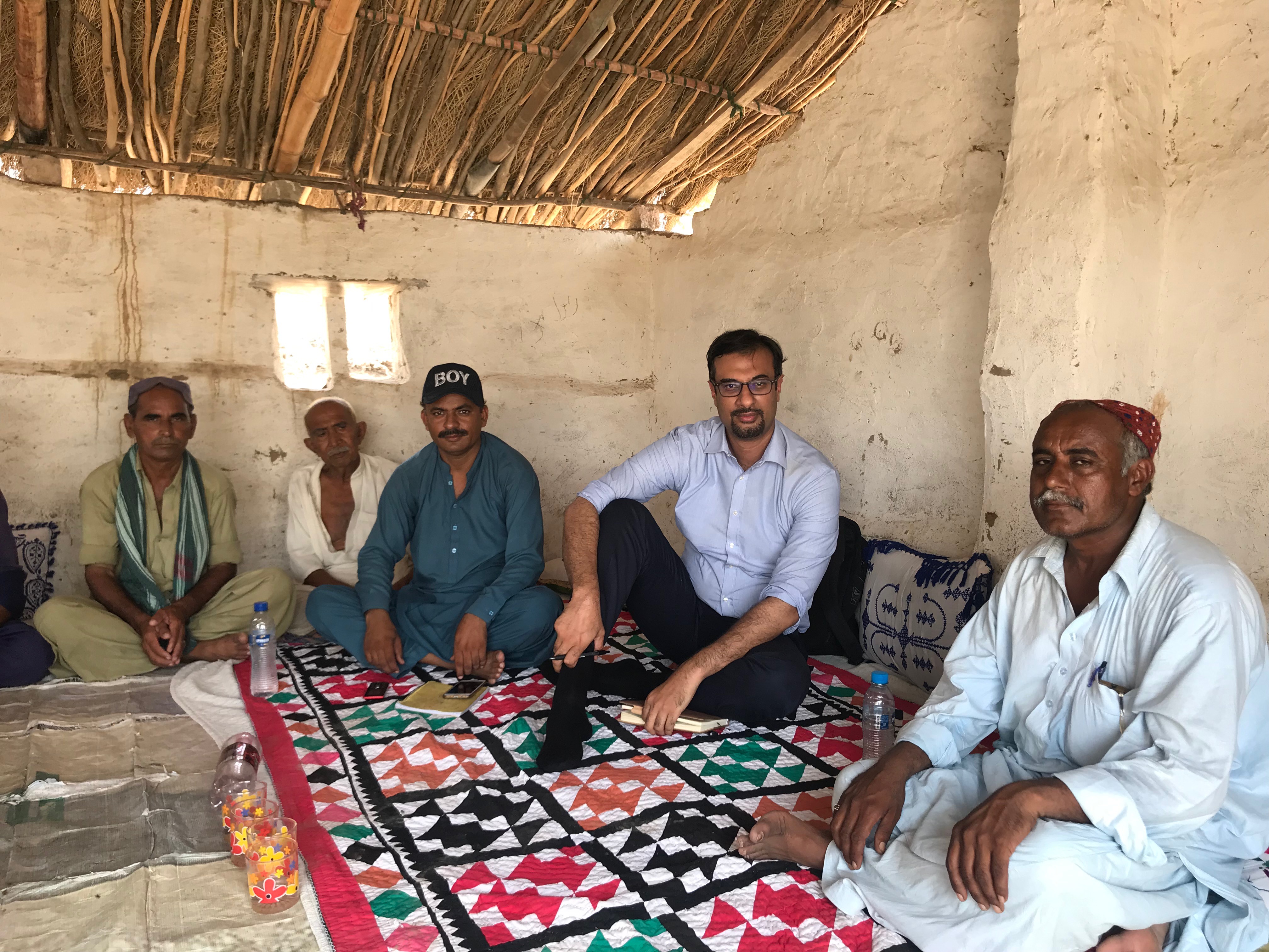Tayyab Safdar doing a focus group with local villagers in Tharparkar, Sindh, Pakistan in 2019 near the site of a Chinese and Pakistani financed open-pit coal mine and power plant.