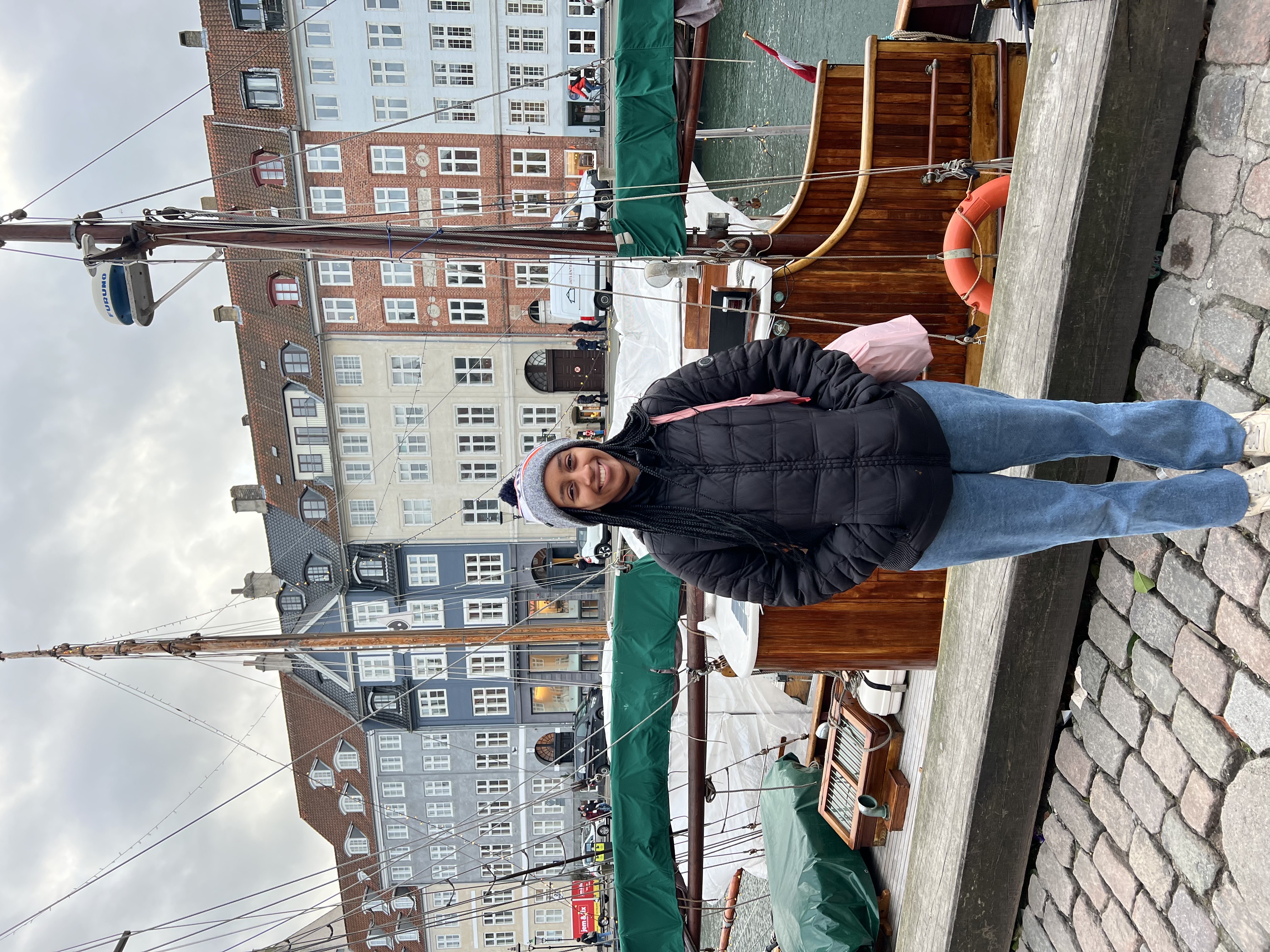 Berhanu in front of ships at a harbor in Scandinavia