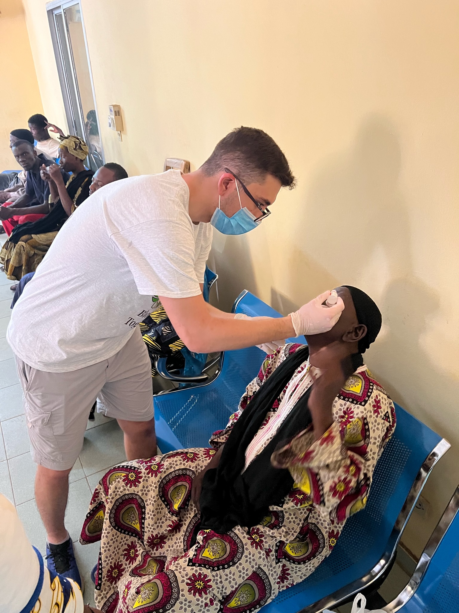 Student administering medicine in Mali