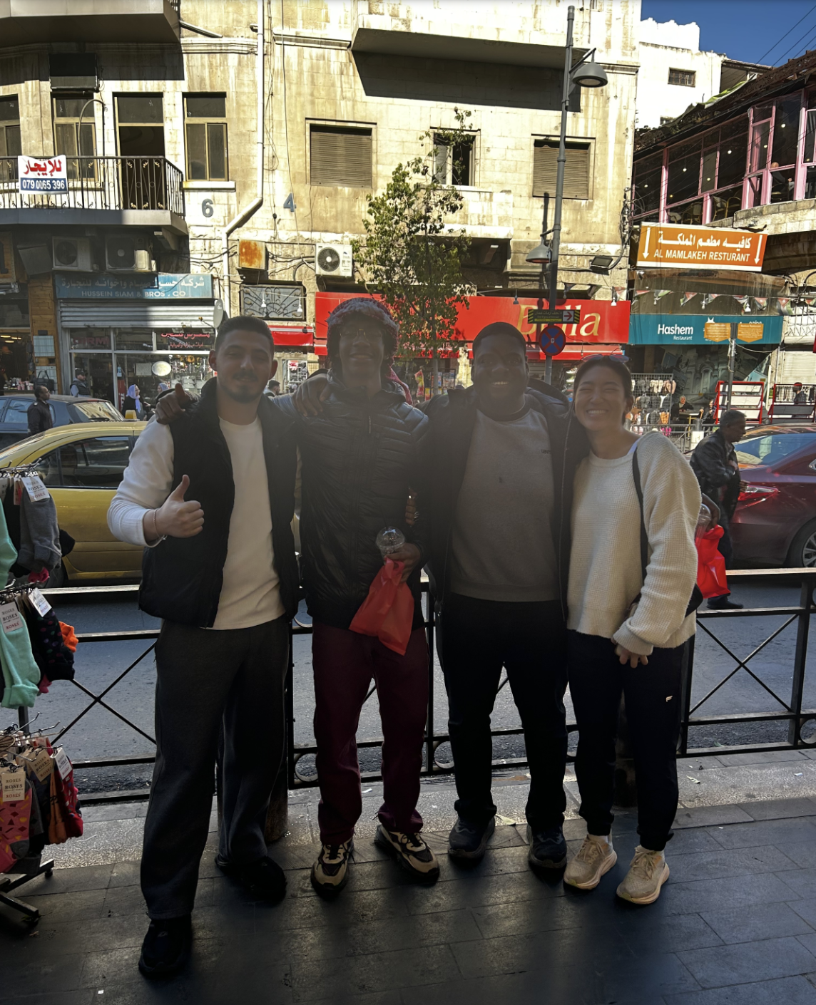 Smith and classmates stand together on a street in Jordan posing for a photo