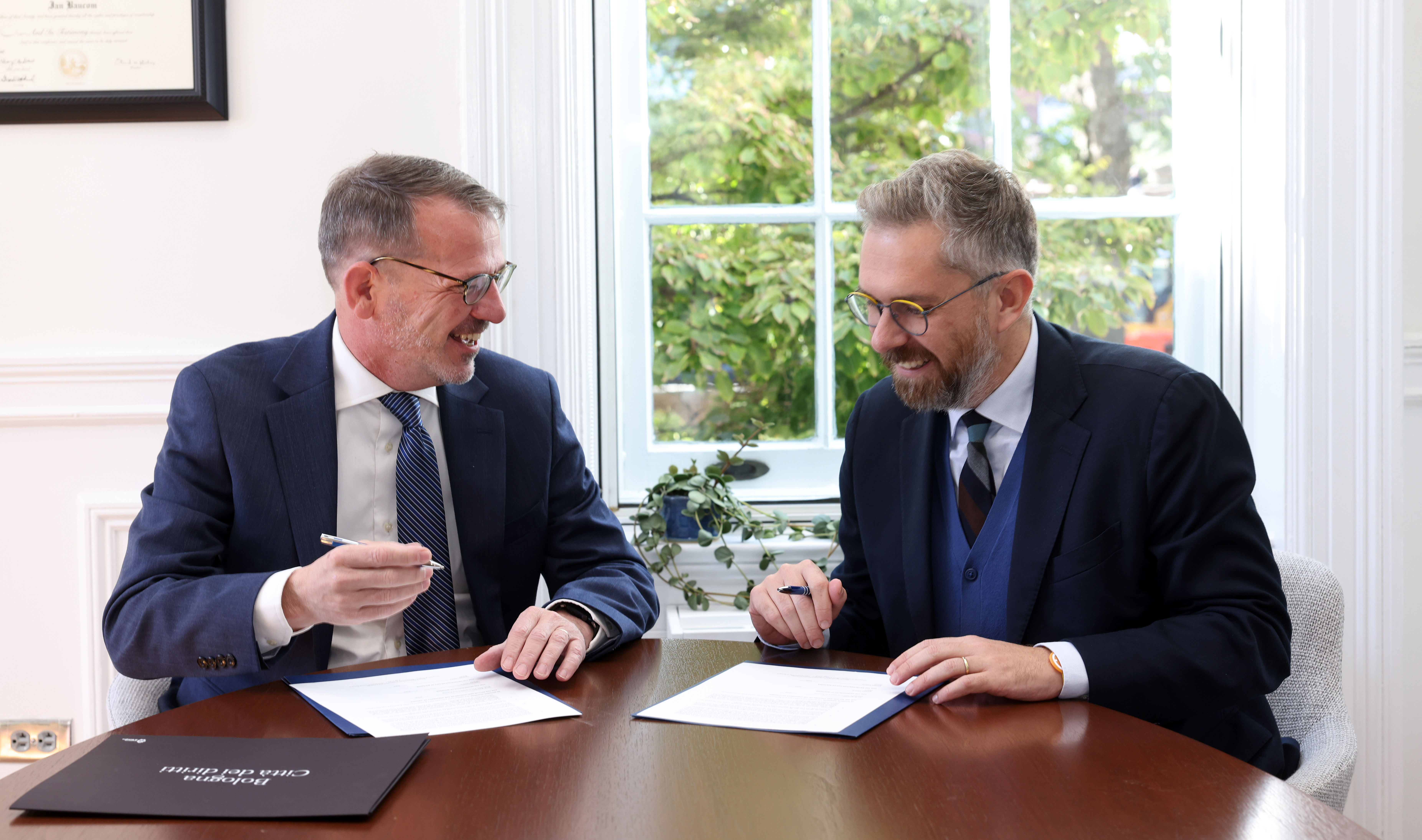 Provost Ian Baucom and Mayor Matteo Lepore smiling as they sign the MoU between UVA and Bologna