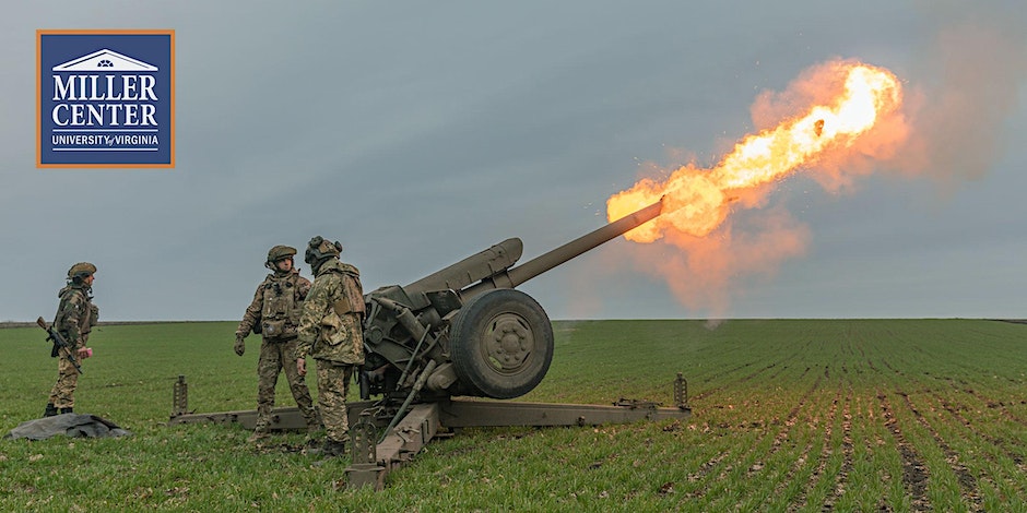 Soldiers in camo suits stand next to large weapon as it fires