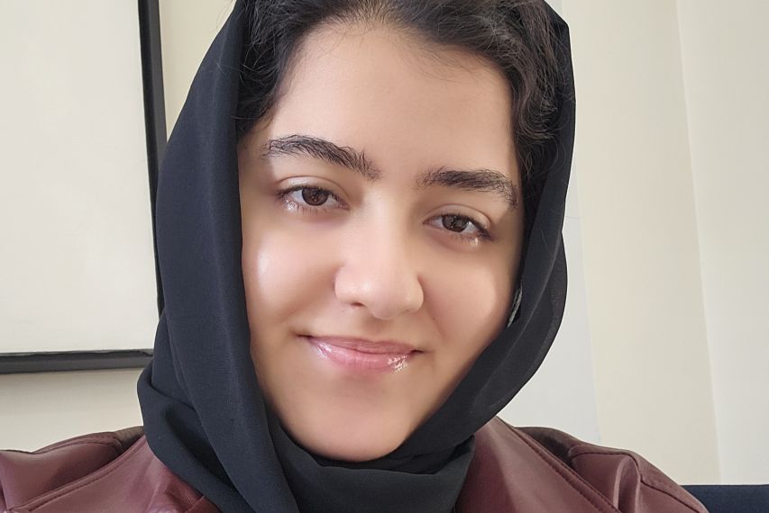 Akbarzada in a black hijab and maroon leather jacket