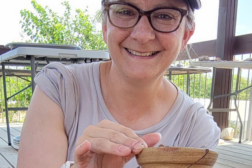 Tyler Jo Smith holding a ceramic wine jar