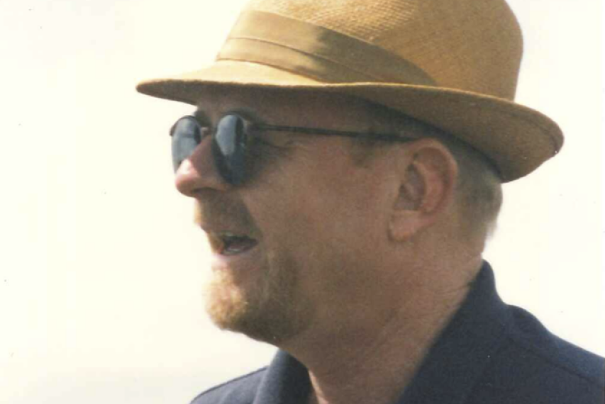 Wills in profile wearing a panama hat
