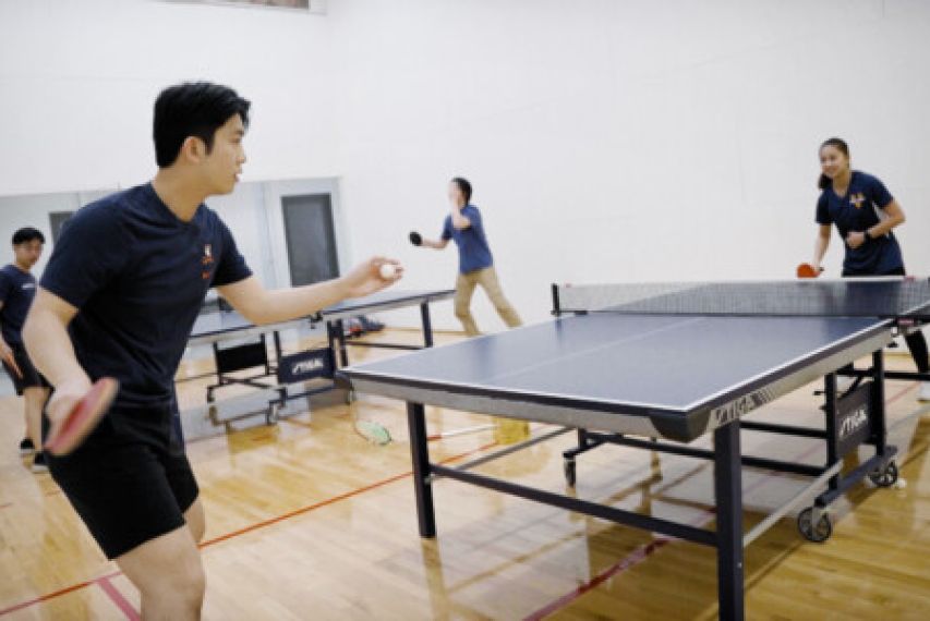 two students playing ping pong