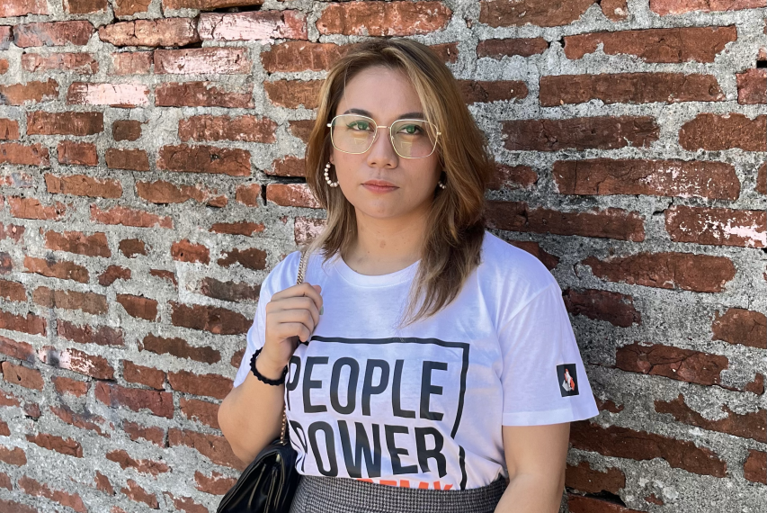 Garcia in front of brick wall wearing people power academy tee