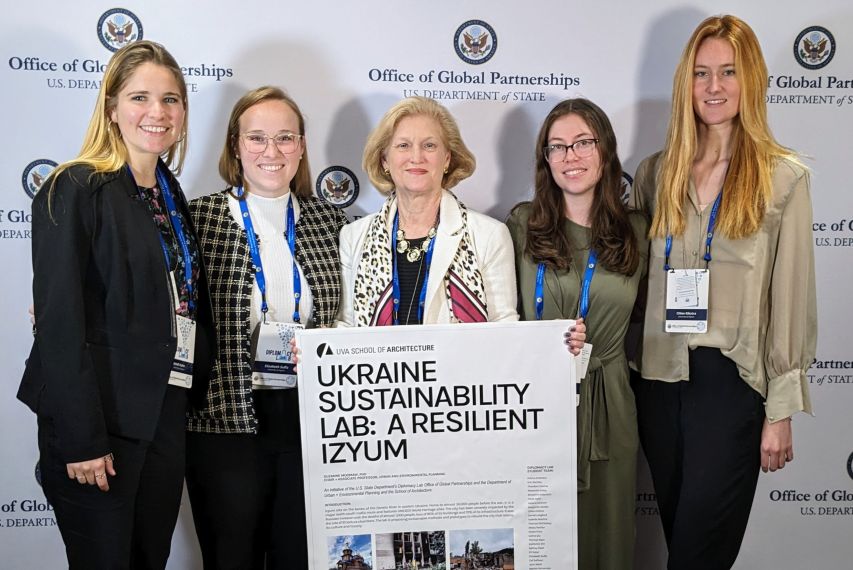 Suzanne Moomaw and students from the UVA School of Architecture team presenting their poster on their project for green recover in Ukraine