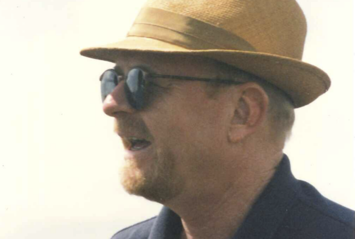 Wills in profile wearing a panama hat