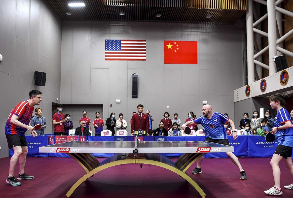 China Office Director Justin O’Jack, left, receives a serve from Corey Skelton, a U.S. foreign service officer, at the International Table Tennis Federation Museum in April. (Photo by Chen Long/Wenhui Daily)