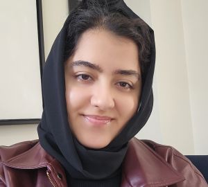 Akbarzada in a black hijab and maroon leather jacket