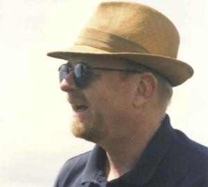 Wills in profile wearing a panama hat