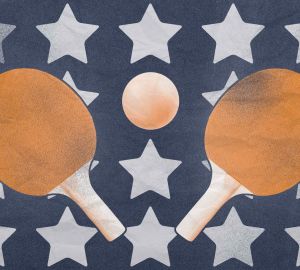 Orange ping pong paddles and ball on navy background with white stars