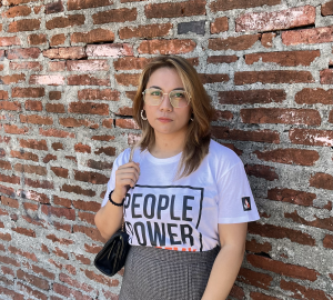 Garcia in front of brick wall wearing people power academy tee