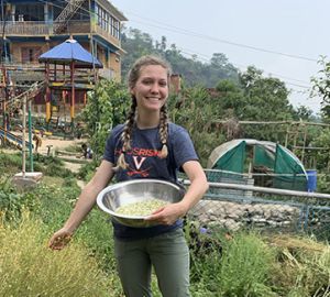 Lea Taylor picking chamomile flowers at Kevin Rohan Memorial Eco Foundation in Nepal. Photo Credit: Lea Taylor