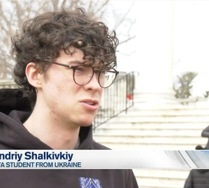 Student speaking in front of Rotunda steps