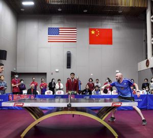 China Office Director Justin O’Jack, left, receives a serve from Corey Skelton, a U.S. foreign service officer, at the International Table Tennis Federation Museum in April. (Photo by Chen Long/Wenhui Daily)